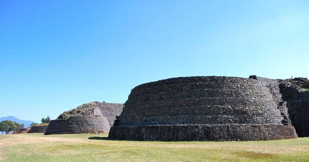 “The rounded yácatas pyramids of Tzintzuntzan, standing tall against the serene backdrop of Lake Pátzcuaro.”