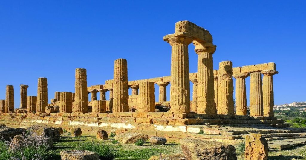 “Valley of the Temples in Agrigento, Sicily, with ancient Greek temples set against a backdrop of rolling hills.”