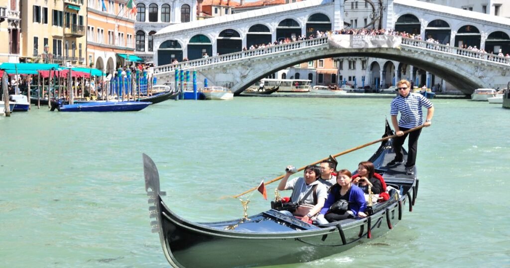 “Gondolas gliding through the canals of Venice, with historic buildings and bridges in the background.”