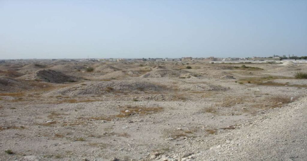 Rows of ancient burial mounds under a clear sky in A’Ali, Bahrain.