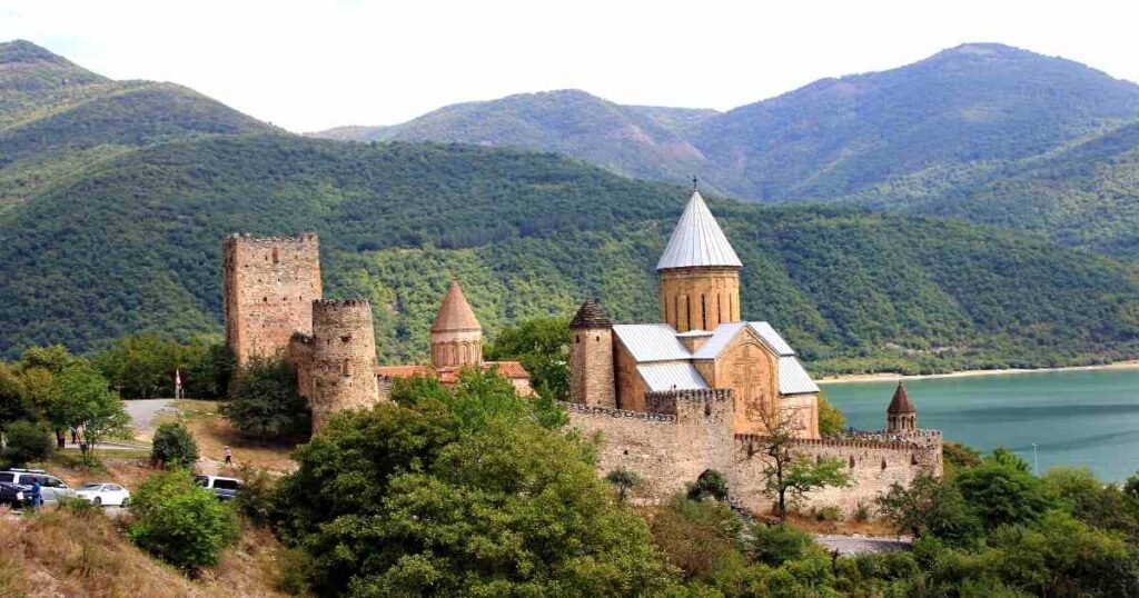 "Ananuri Fortress overlooking the turquoise waters of the Zhinvali Reservoir."