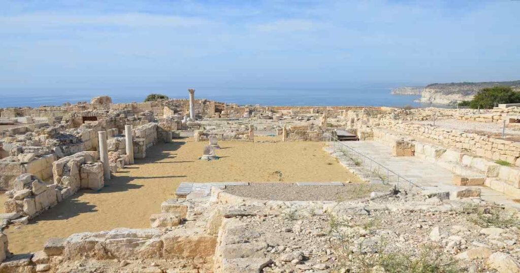 "The Greco-Roman theater at Kourion overlooking the Mediterranean coastline under a clear blue sky."