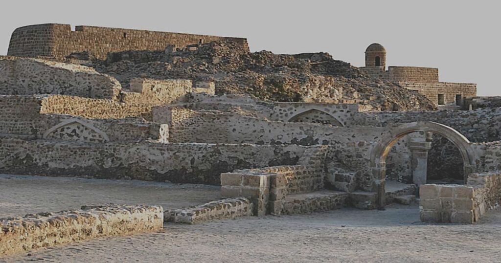 Ancient Bahrain Fort against a sunset sky.