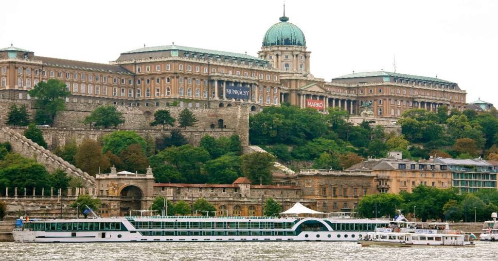 "Majestic view of Buda Castle overlooking the Danube River in Budapest."