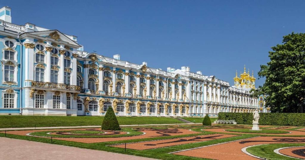 “Ornate blue and white facade of Catherine Palace with golden domes against a clear sky.”