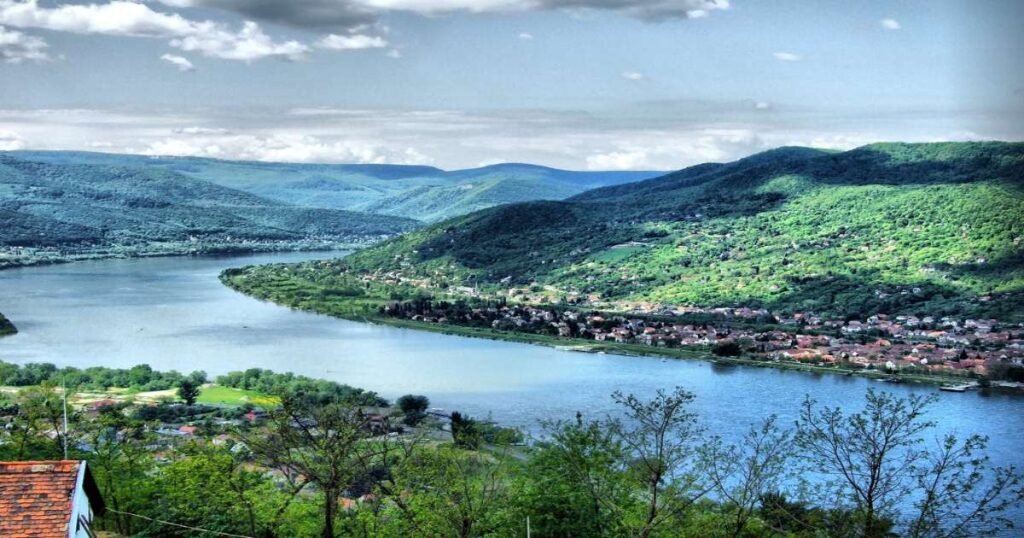 “Kayakers paddling along the Danube River with Visegrád Castle visible on a distant hill.”