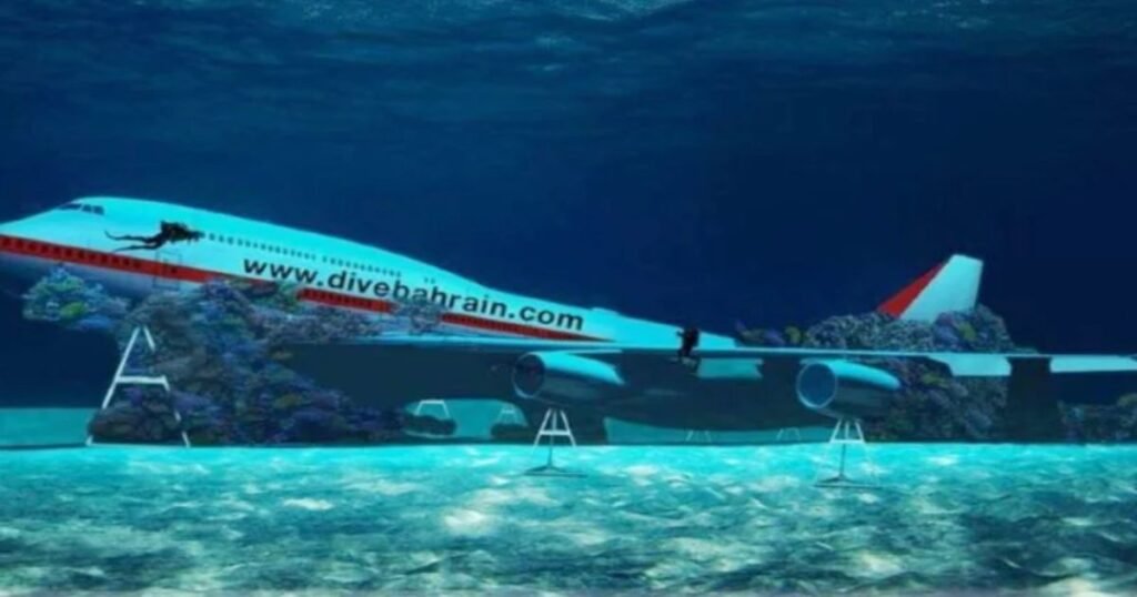 “Divers exploring a submerged Boeing 747 at Dive Bahrain with fish swimming around.”