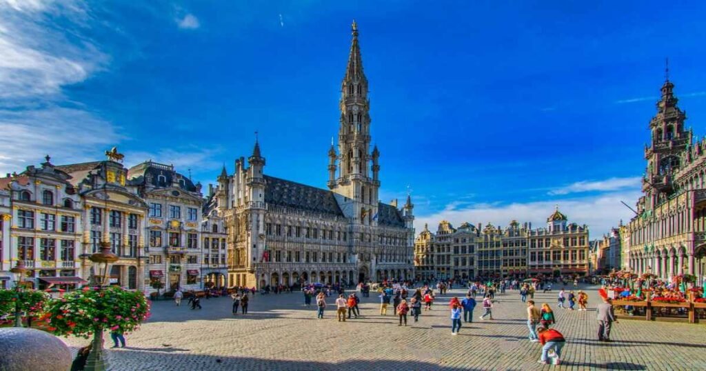 "The historic Grand Place in Brussels, surrounded by ornately decorated guildhalls and the Town Hall."