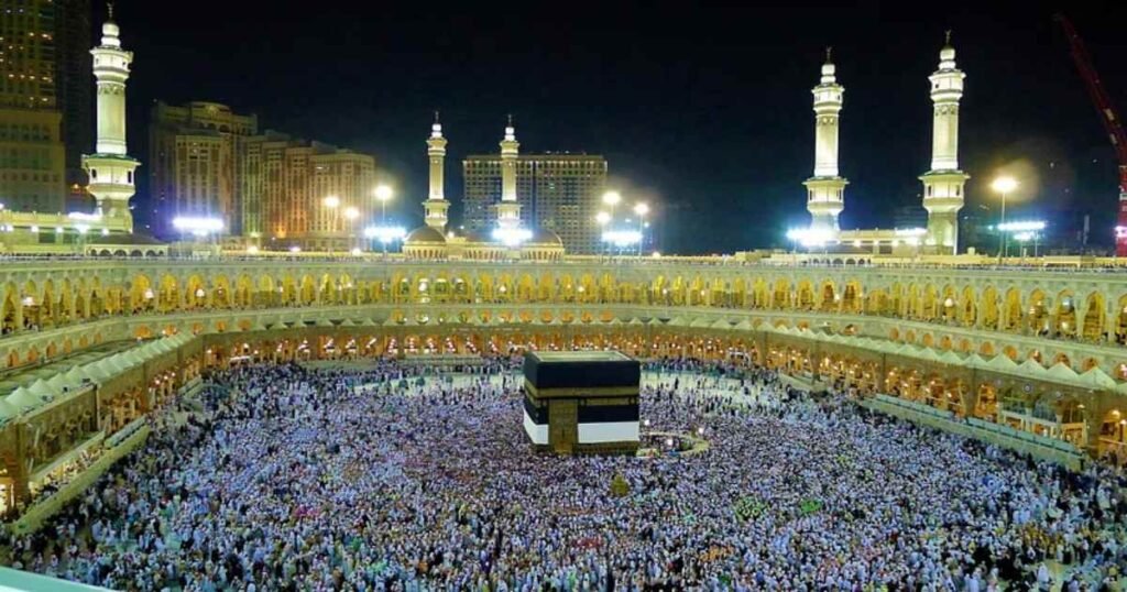 "The Grand Mosque of Mecca with the Kaaba at its center, surrounded by worshippers."