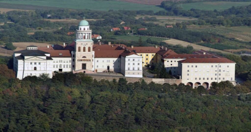 "Historic Pannonhalma Archabbey complex surrounded by lavender fields in Hungary."