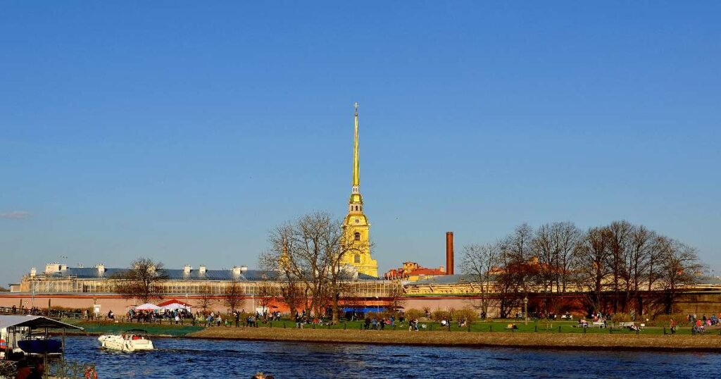 “The iconic Peter and Paul Fortress, with the tall spire of Peter and Paul Cathedral rising against the St. Petersburg skyline.”