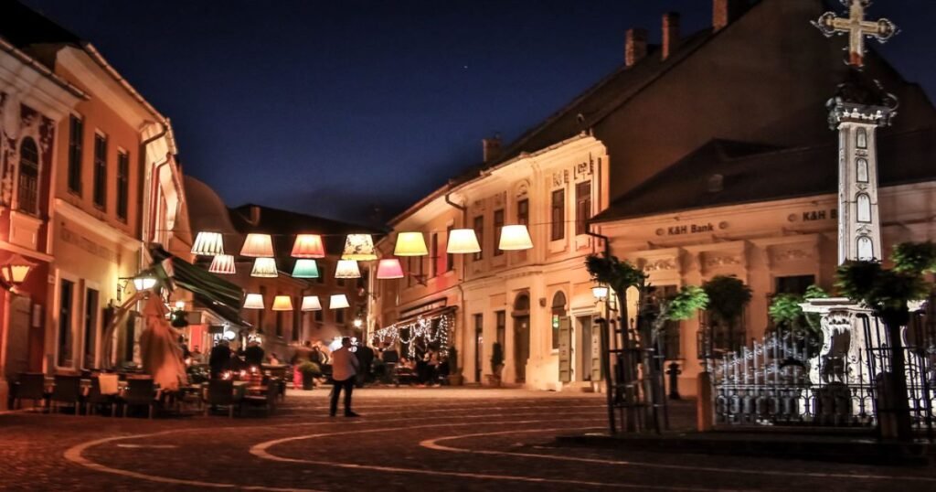 "Quaint streets of Szentendre illuminated at night, with cobblestone roads, and an artistic ambiance in Hungary."