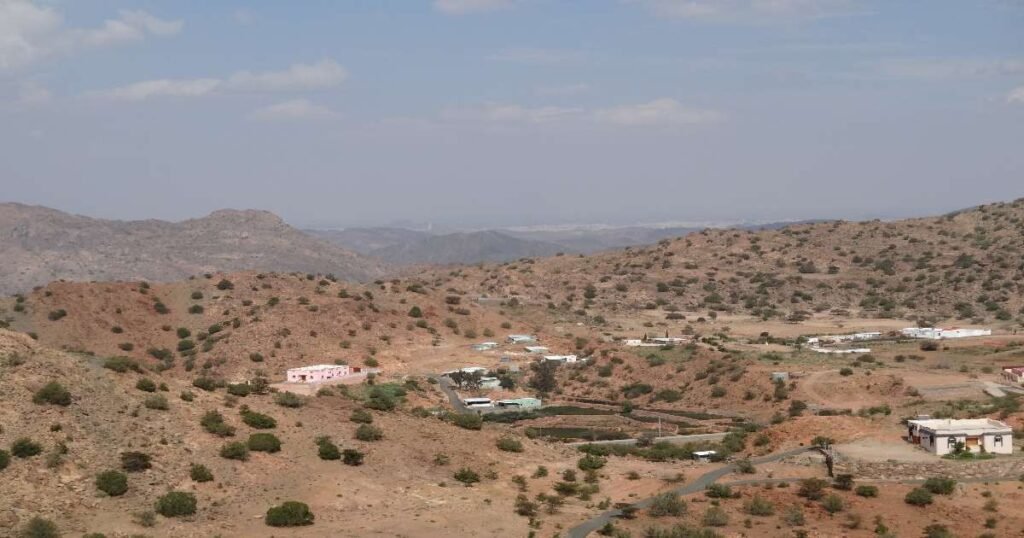 "A view of Taif’s mountainous landscape, dotted with vibrant rose gardens in full bloom."