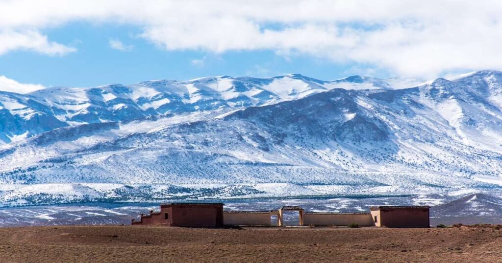  "A scenic view of the Atlas Mountains with rugged peaks and Berber villages."