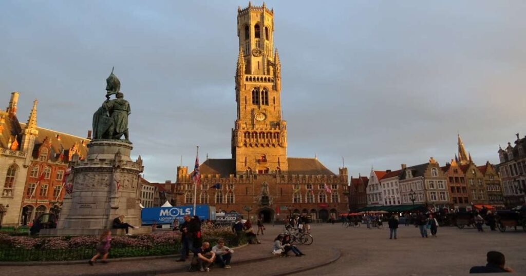 "The medieval Belfry of Bruges towering over the historic market square."