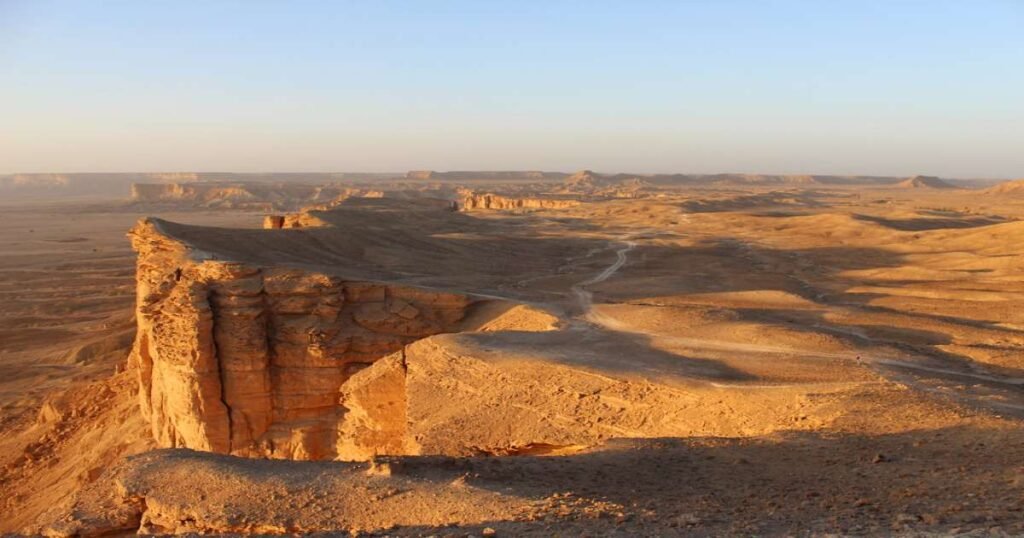 "The Edge of the World cliffs, with endless desert views stretching to the horizon."