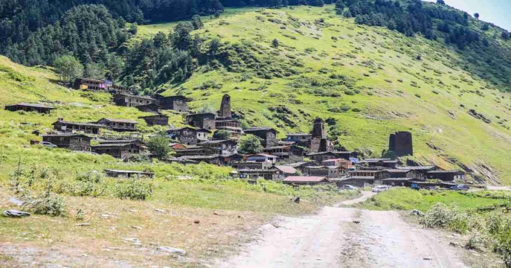 "Traditional Tushetian village surrounded by majestic mountains."