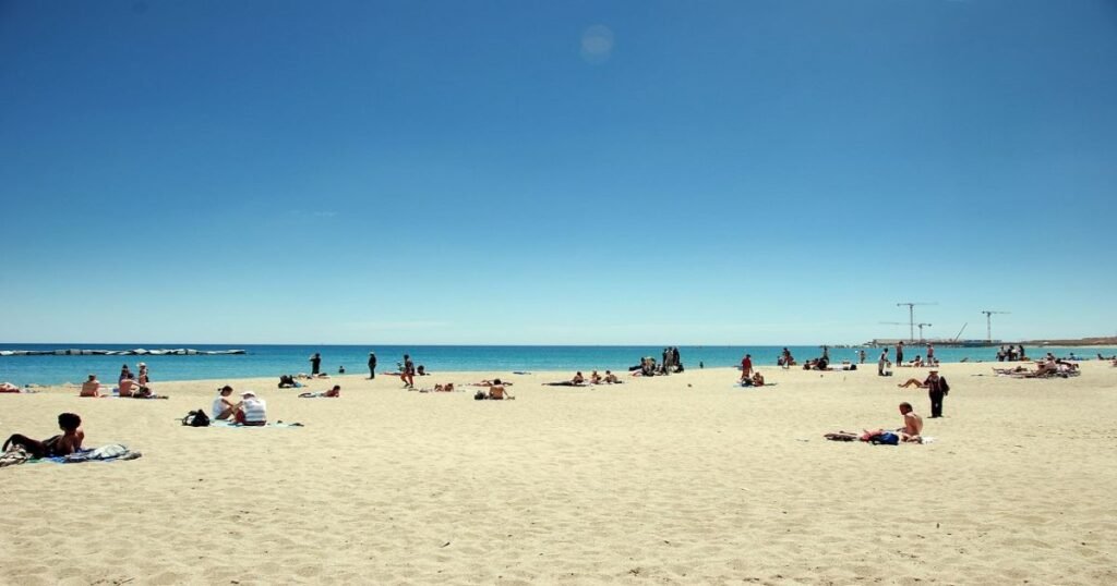 People relaxing at Barceloneta Beach