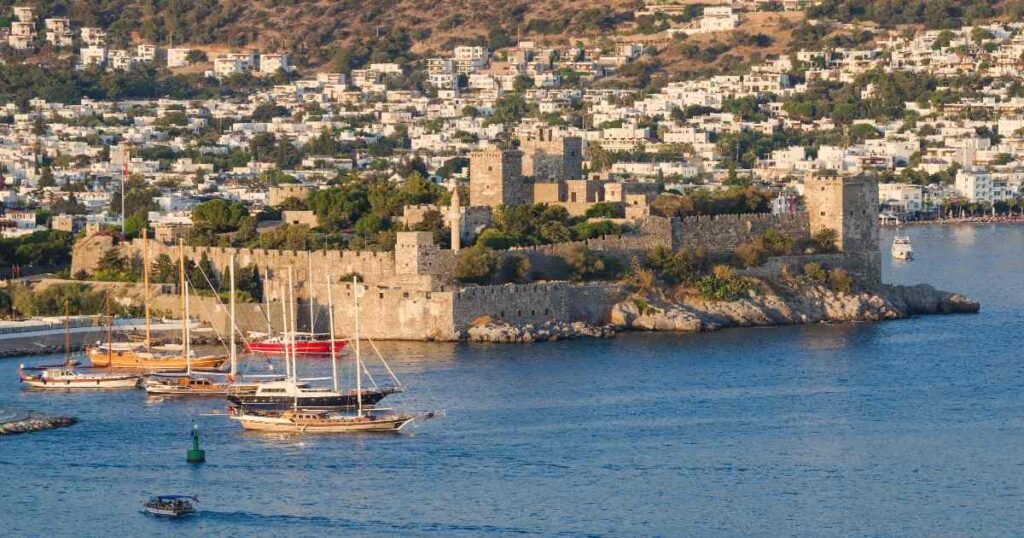Bodrum Castle surrounded by turquoise waters and anchored boats.