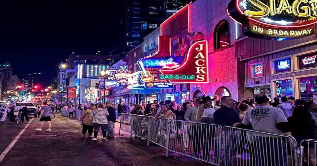 Broadway in downtown Nashville, lined with neon-lit bars and music venues.