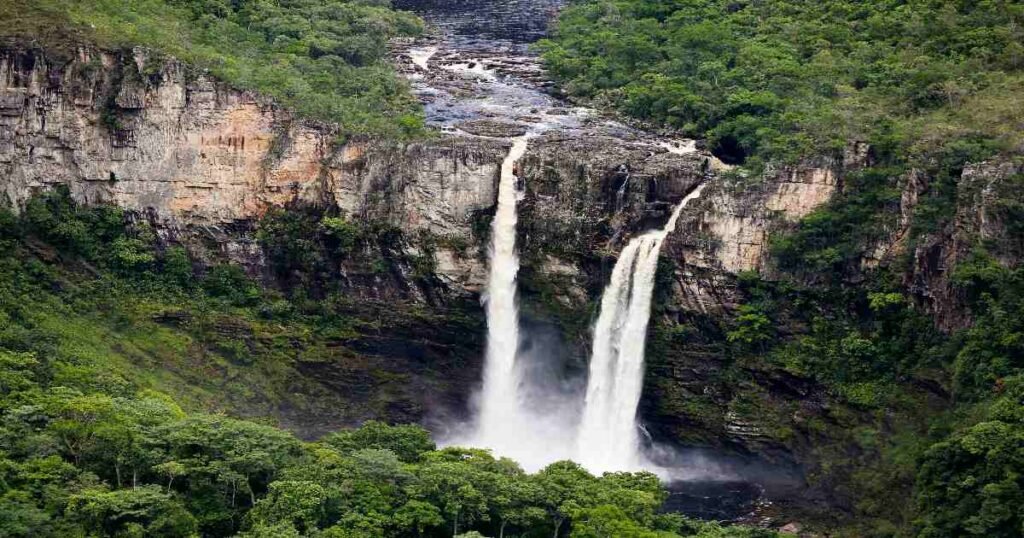  "A waterfall cascading into a clear pool in Chapada dos Veadeiros."