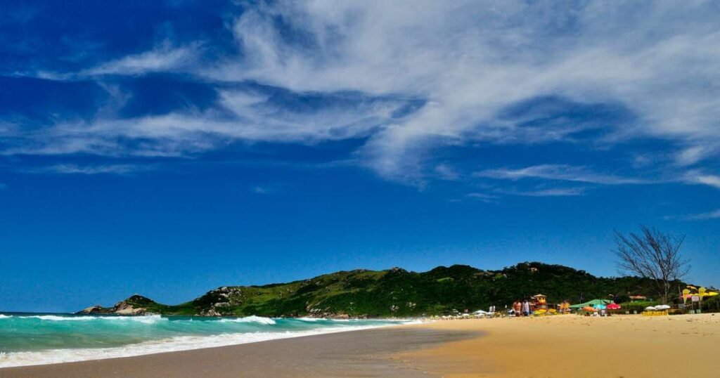 "A beautiful beach with turquoise waters and white sand in Florianópolis."