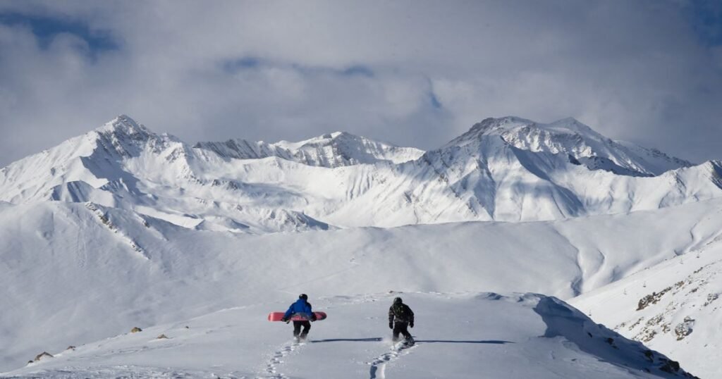 “Skiers and snowboarders on the slopes of Gudauri with a backdrop of the Greater Caucasus Mountains.”