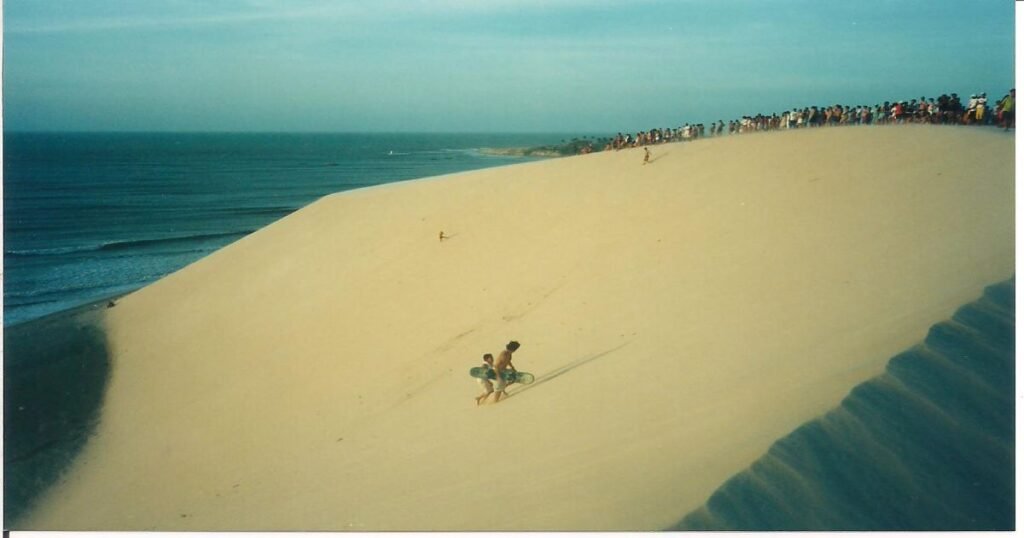 "Golden sand dunes meeting the ocean in Jericoacoara."