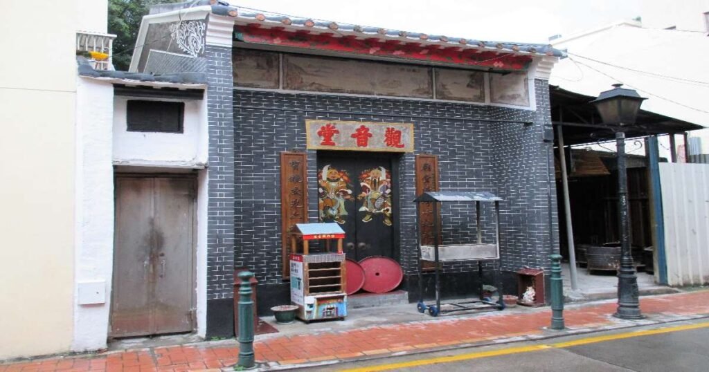 "The entrance of Kun Iam Temple, adorned with ornate carvings and traditional Chinese architecture."