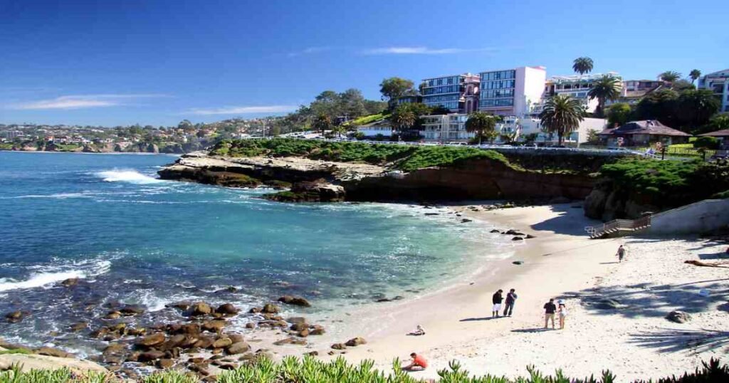 La Jolla Cove with its rocky shoreline and clear blue waters.