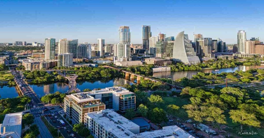 Aerial view of the Downtown Austin skyline with Lady Bird Lake in the foreground.