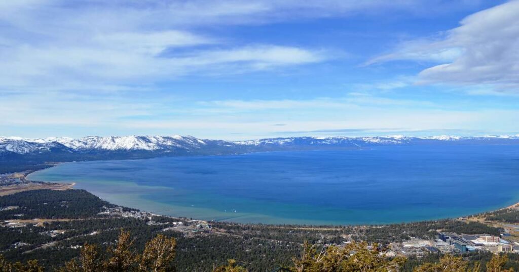 Panoramic view of the lake Tahoe with snow-covered mountains in the background