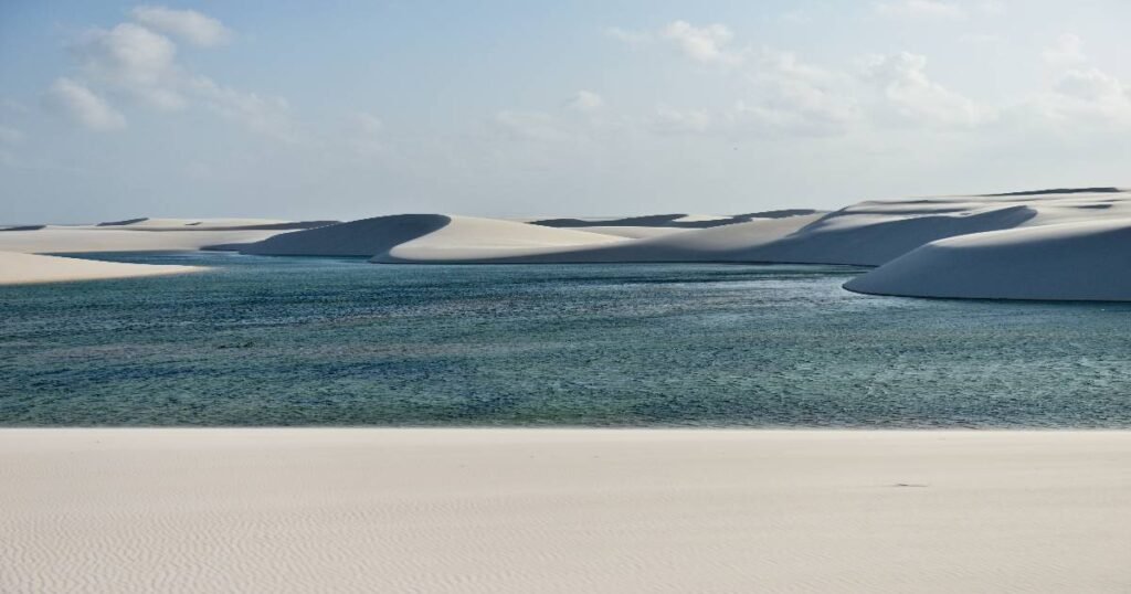 "A pristine lagoon nestled between white sand dunes in Lençóis Maranhenses National Park."