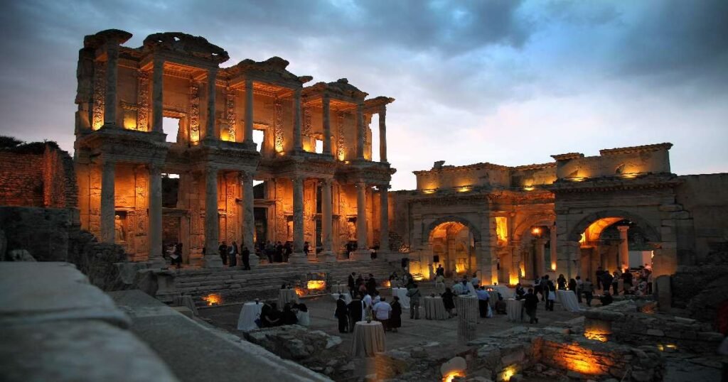 The grand facade of the Library of Celsus in Ephesus illuminated at dusk.