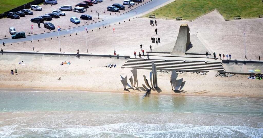 Omaha Beach with its golden sands and commemorative monuments.