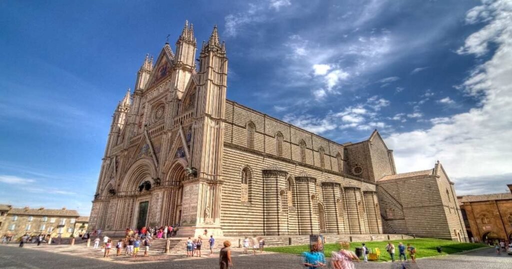 The magnificent facade of Orvieto Cathedral with its intricate mosaics and sculptures.