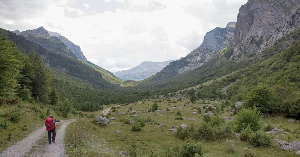 “Rugged peaks and green valleys in Prokletije National Park under clear blue skies.”