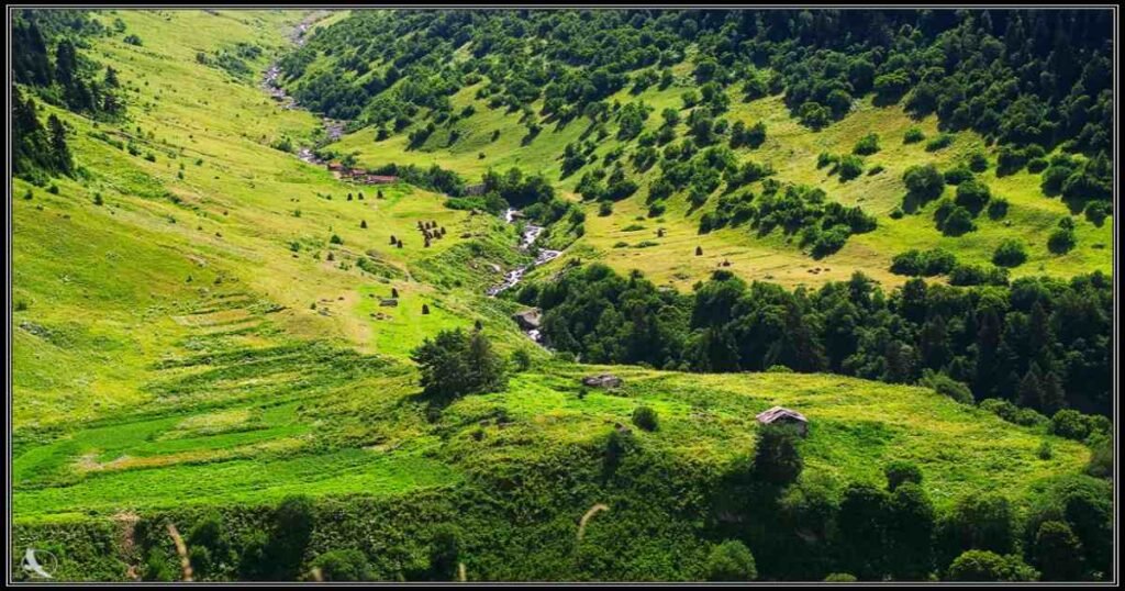 “Rolling green hills and distant mountain peaks in the Racha region of Georgia.”