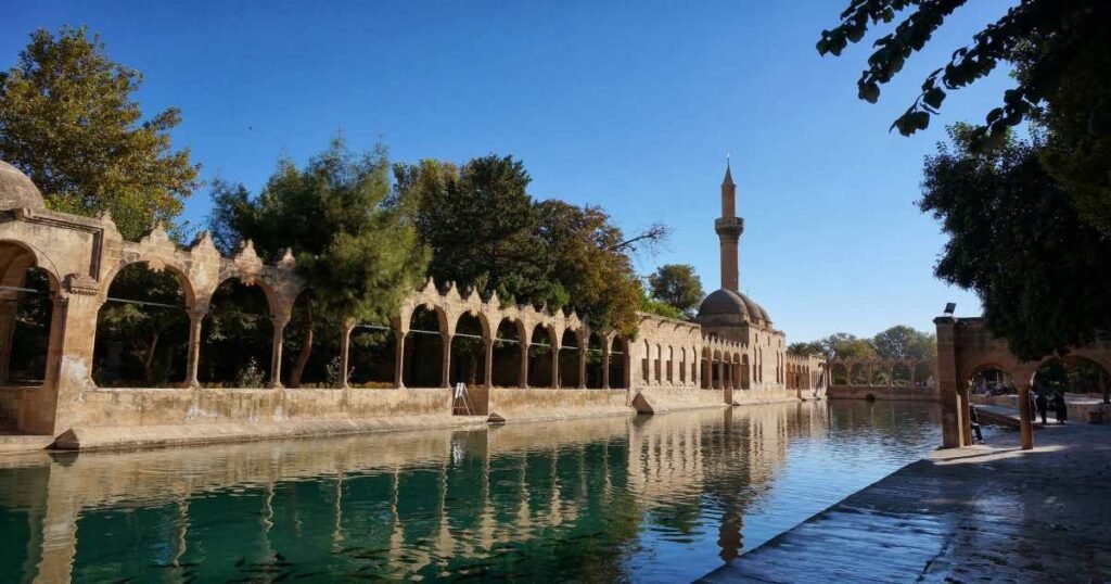 The Pool of Sacred Fish in Şanlıurfa surrounded by historic architecture.
