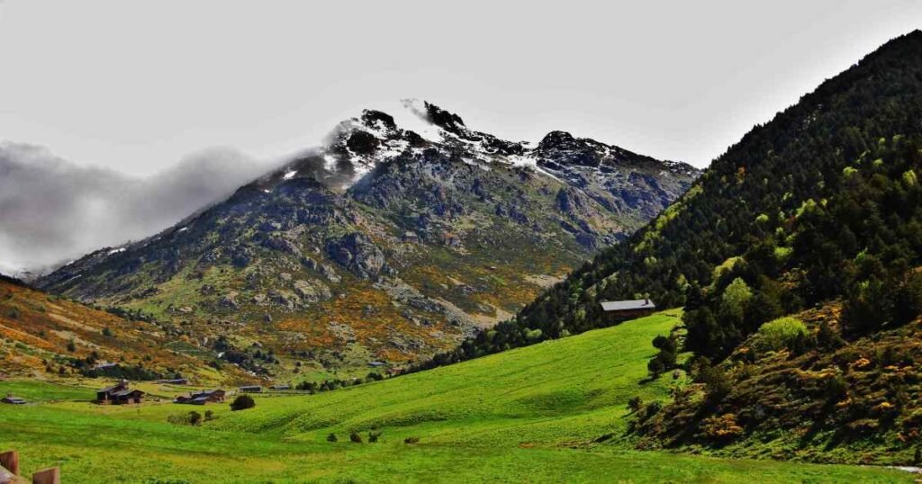 “Green meadows and mountain peaks in Vall d’Incles with a winding river.”