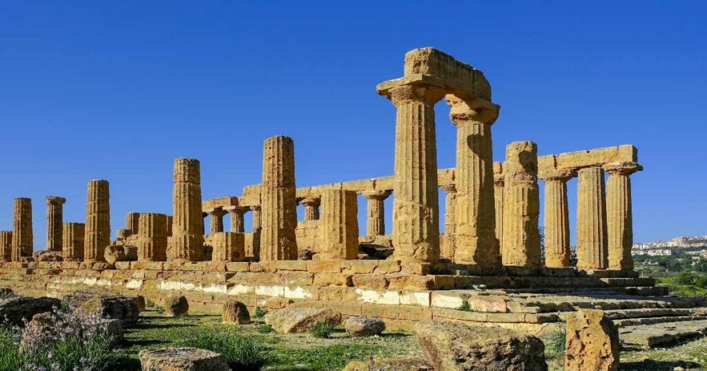 “Valley of the Temples in Agrigento, Sicily, with ancient Greek temples set against a backdrop of rolling hills.”