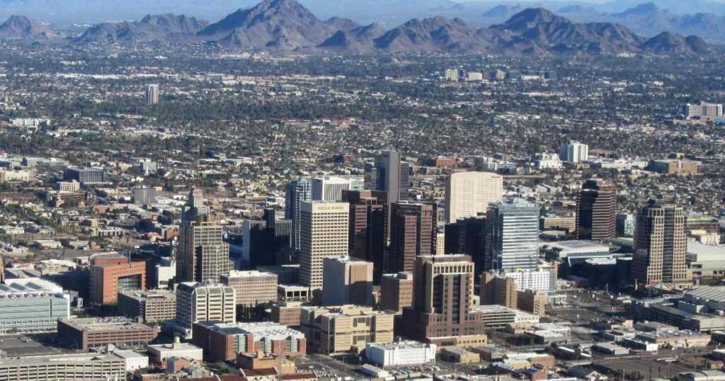 Aerial view of downtown Phoenix with Camelback Mountain in the background.