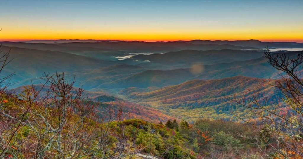 The lush, foggy landscapes of the Great Smoky Mountains at sunrise.