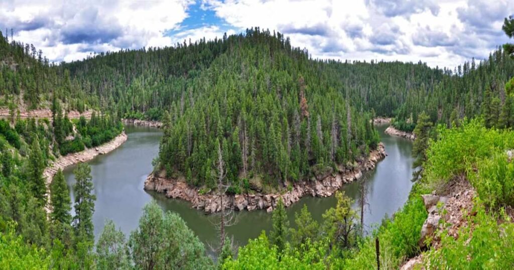 A serene view of Lake Blue Ridge surrounded by forested hills.