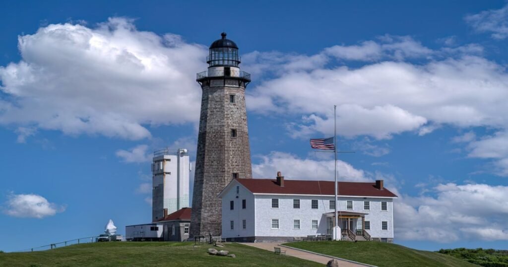 Montauk Point Lighthouse standing against the blue sky.