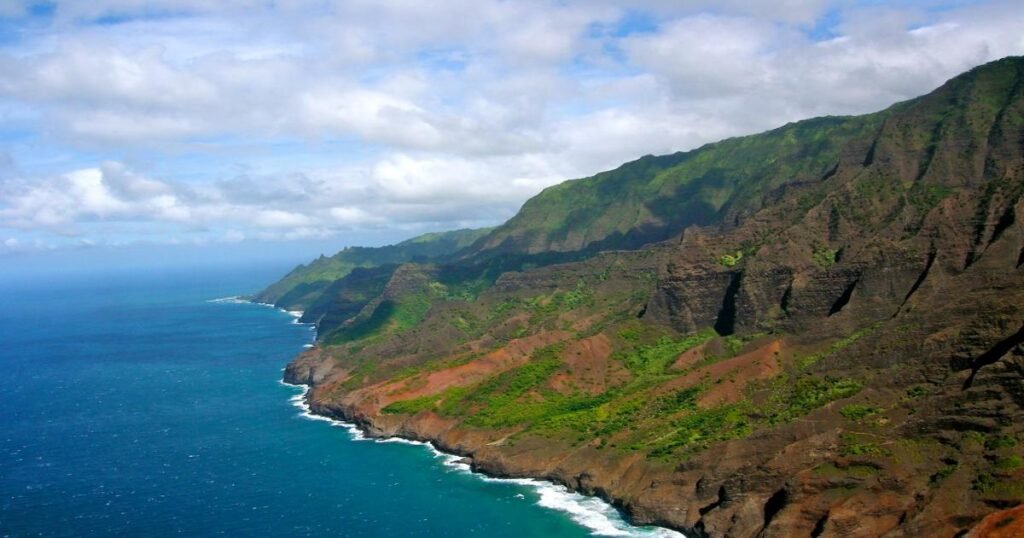 The dramatic cliffs of the Nā Pali Coast with the Pacific Ocean in the background.