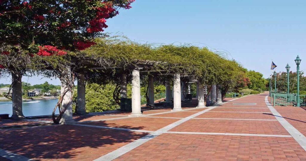 The Augusta Riverwalk with lush greenery and the Savannah River in the background.