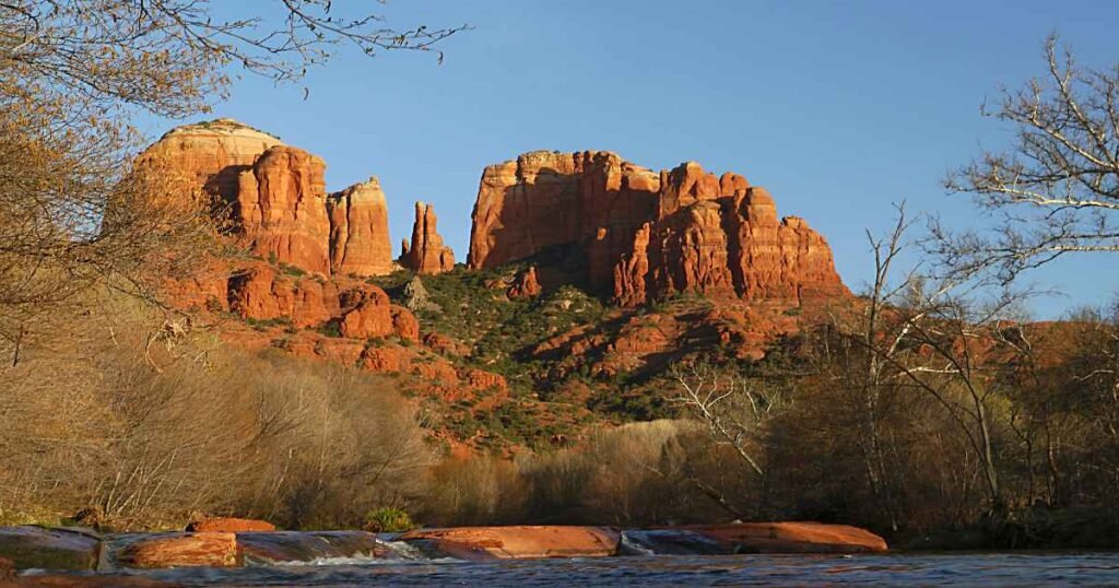 Cathedral Rock in Sedona, surrounded by vibrant desert foliage.