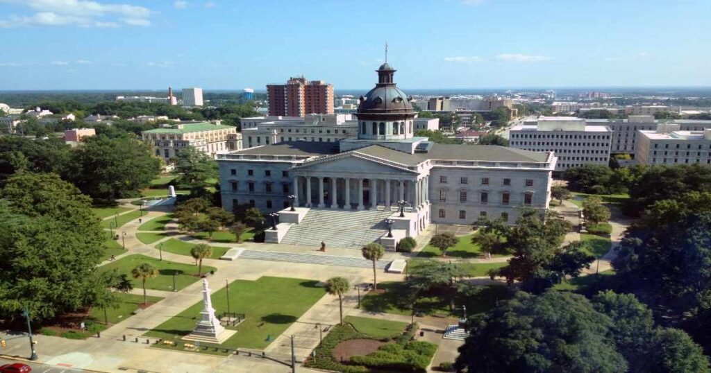 An aerial view of the South Carolina State House with a garden in the foreground.