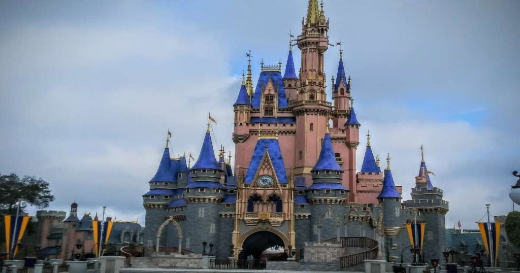 The Cinderella Castle in Walt Disney World surrounded by cheerful visitors.